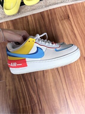 Nike White Low-Top Sneaker with Blue, Yellow & Red Accents